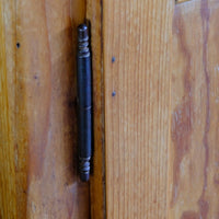 Close up of the brass and steel pin hinges on an Early 20th Century Pitch Pine Single Door Larder Cupboard with Lift-Off Hinges and Original Sprung Latch