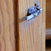 Close up of the Original sprung steel refrigerator-style latch on an Early 20th Century Pitch Pine Single Door Larder Cupboard with Lift-Off Hinges and Original Sprung Latch