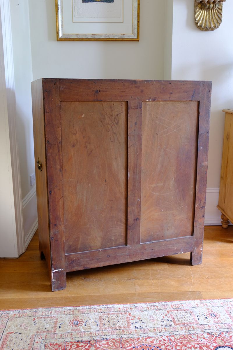 Solid framed back on a Late Georgian Anglo-Chinese Padauk Chest of Drawers with Mitred Face Frame and Original Brass Side Carrying Handles