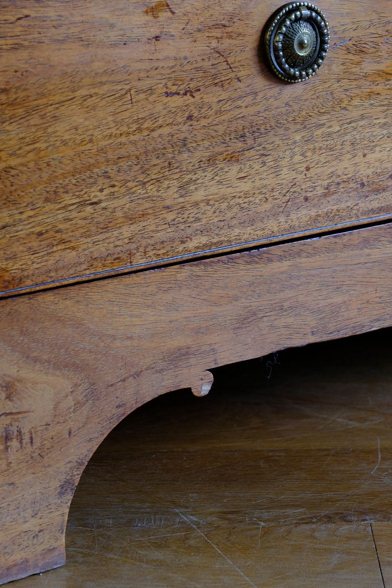 Showing the scroll plinth on a Late Georgian Anglo-Chinese Padauk Chest of Drawers with Mitred Face Frame and Original Brass Side Carrying Handles