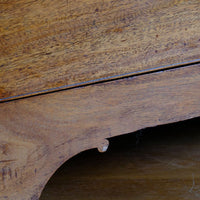 Showing the scroll plinth on a Late Georgian Anglo-Chinese Padauk Chest of Drawers with Mitred Face Frame and Original Brass Side Carrying Handles