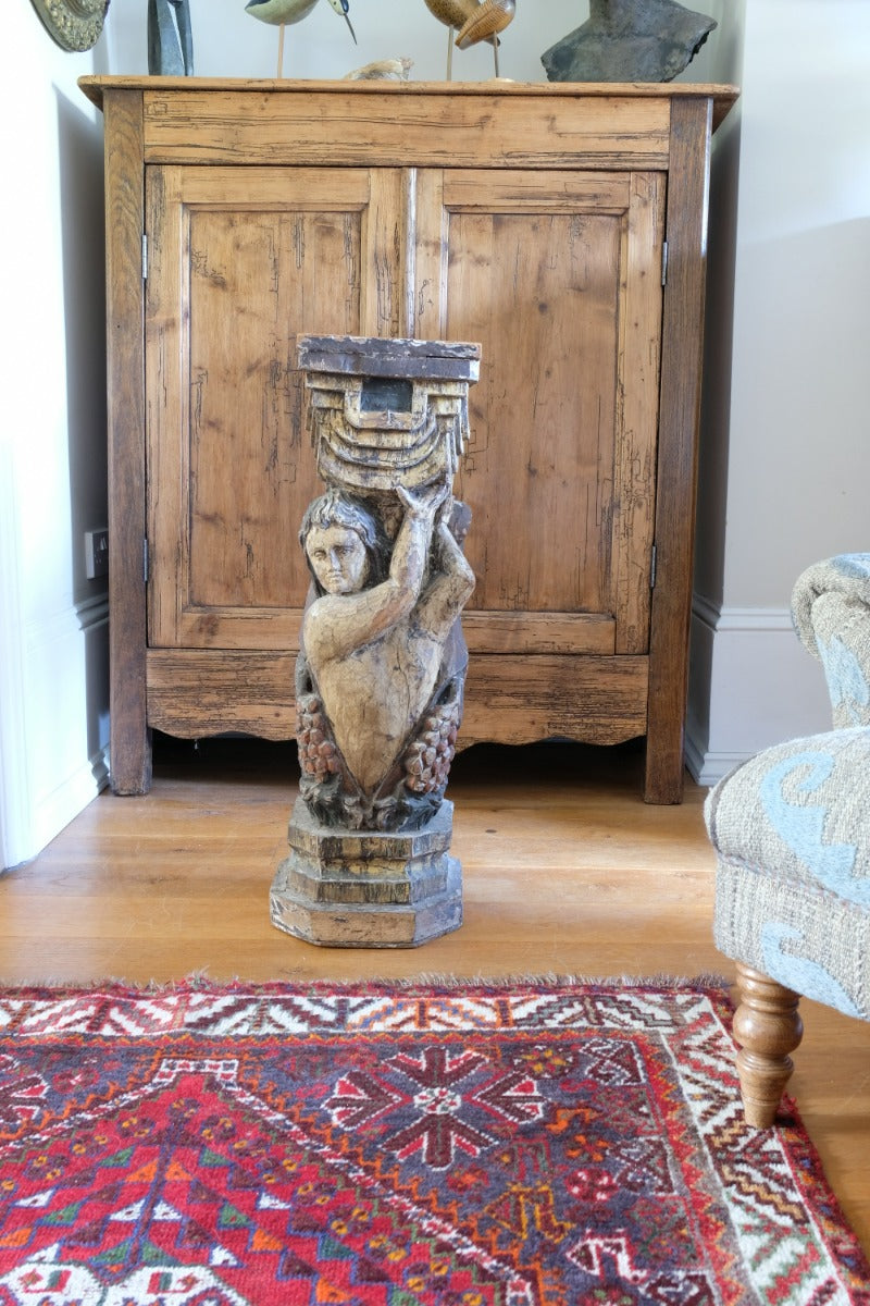 Carved Polychrome Pedestal Sculpture Of A Putto