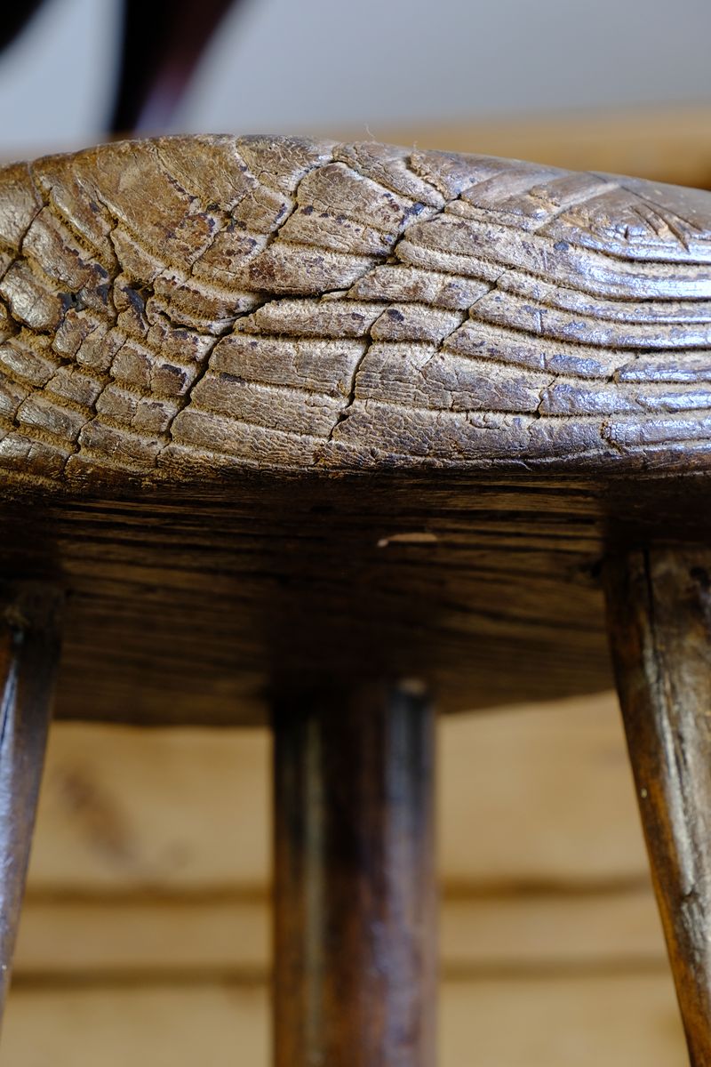 Weathered worn edge detial on a Early 20th Century Elm Milking Stool with Thick Weathered Seat and Original Patina