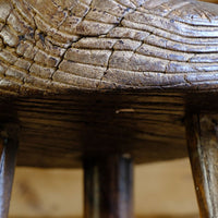 Weathered worn edge detial on a Early 20th Century Elm Milking Stool with Thick Weathered Seat and Original Patina