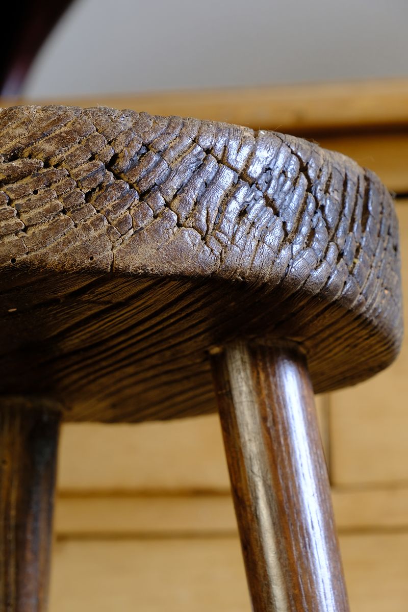 Cracked detail on an Early 20th Century Elm Milking Stool with Thick Weathered Seat and Original Patina