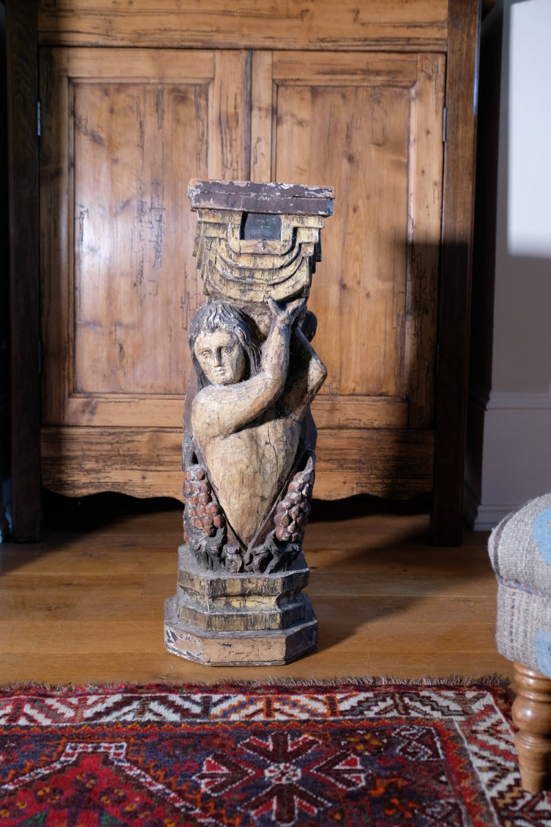 Carved Polychrome Pedestal Sculpture Of A Putto