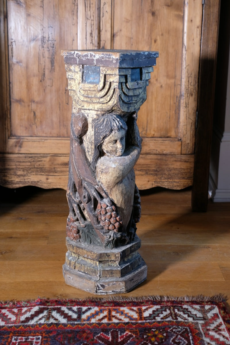 Carved Polychrome Pedestal Sculpture Of A Putto