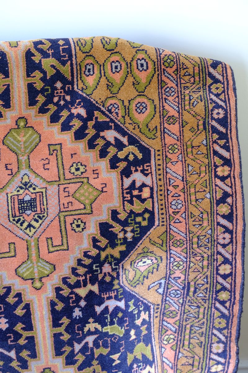 Full-length antique North-West Persian village hall runner with stepped geometric medallions and coral, indigo and ivory palette, Heriz district, c.1930–1950