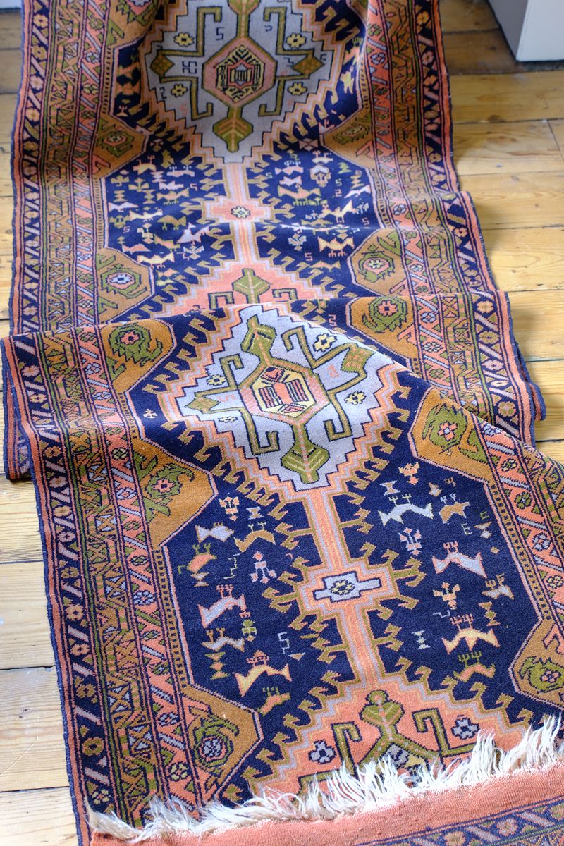 Geometric border detail on an antique Heriz district village hall runner