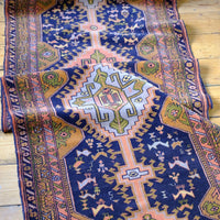 Geometric border detail on an antique Heriz district village hall runner