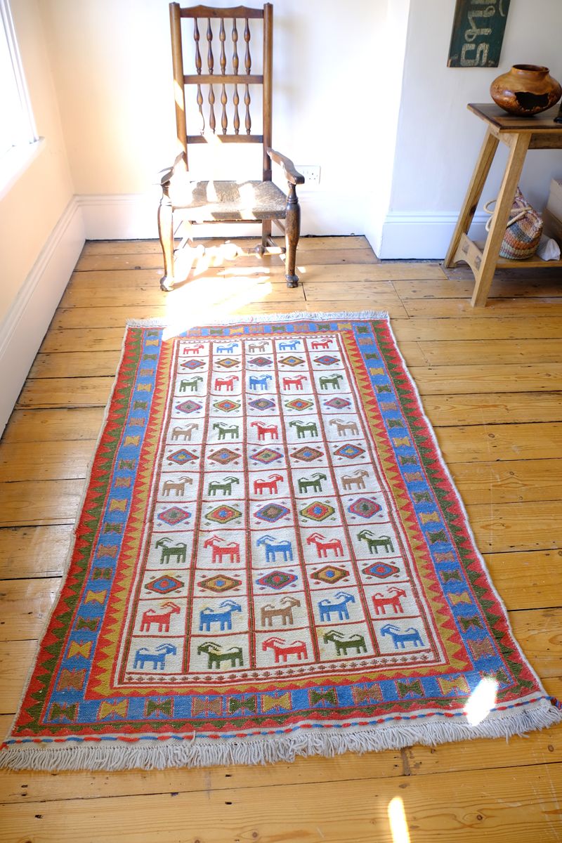 Vintage Persian Sumak flatweave rug with stylised goat and geometric motifs on an ivory ground