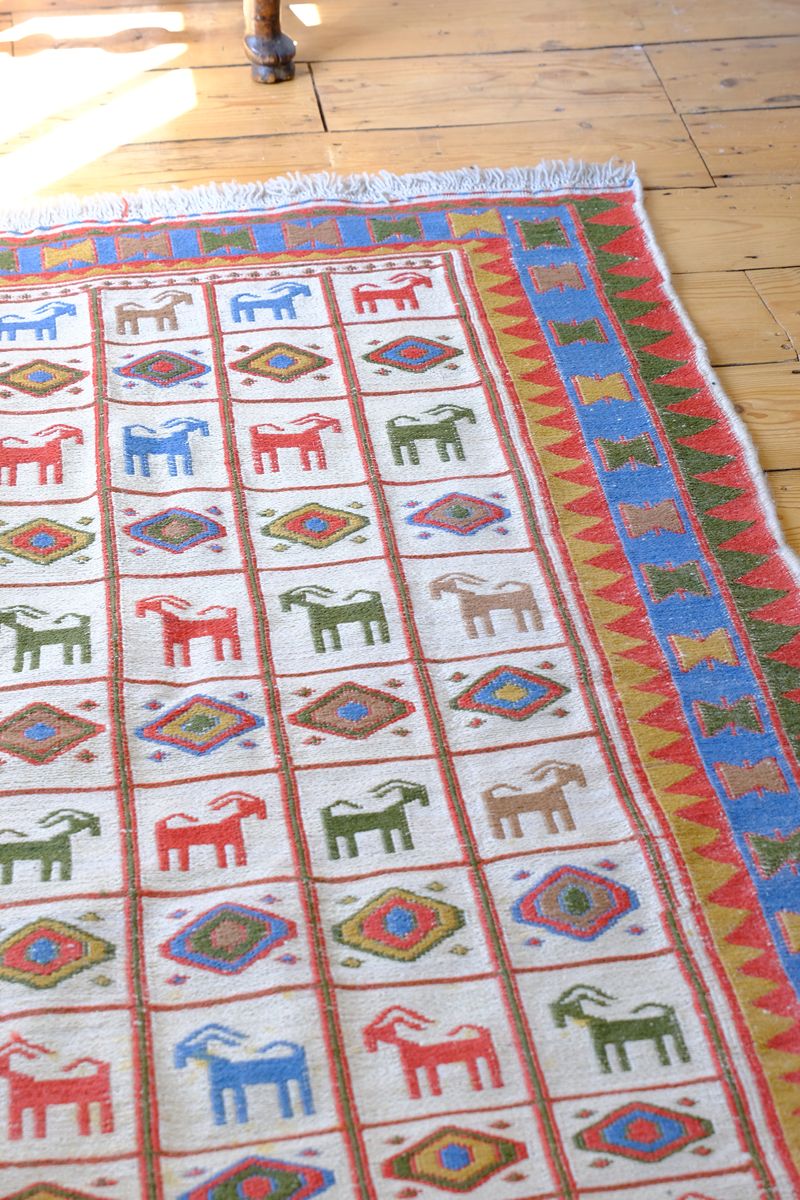Vintage Persian flatweave Sumak rug with compartmentalised goat pattern and ivory field