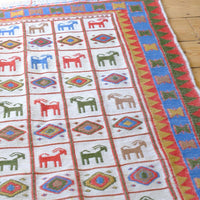Vintage Persian flatweave Sumak rug with compartmentalised goat pattern and ivory field