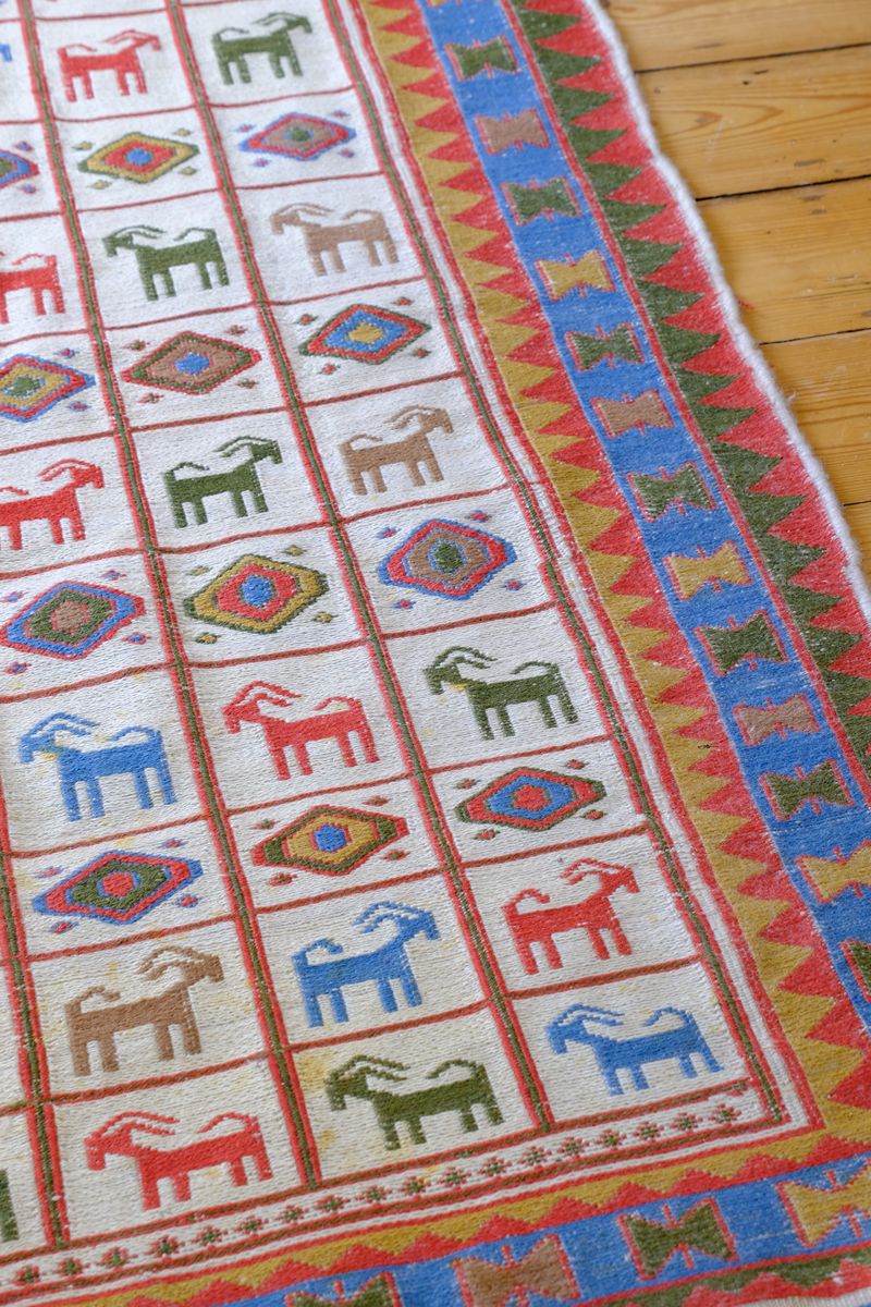 Traditional Persian Sumak wool flatweave rug with repeating goat motifs and geometric design
