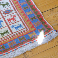 Persian Sumak flatweave rug showing wrapped-weft construction and stylised tribal motifs