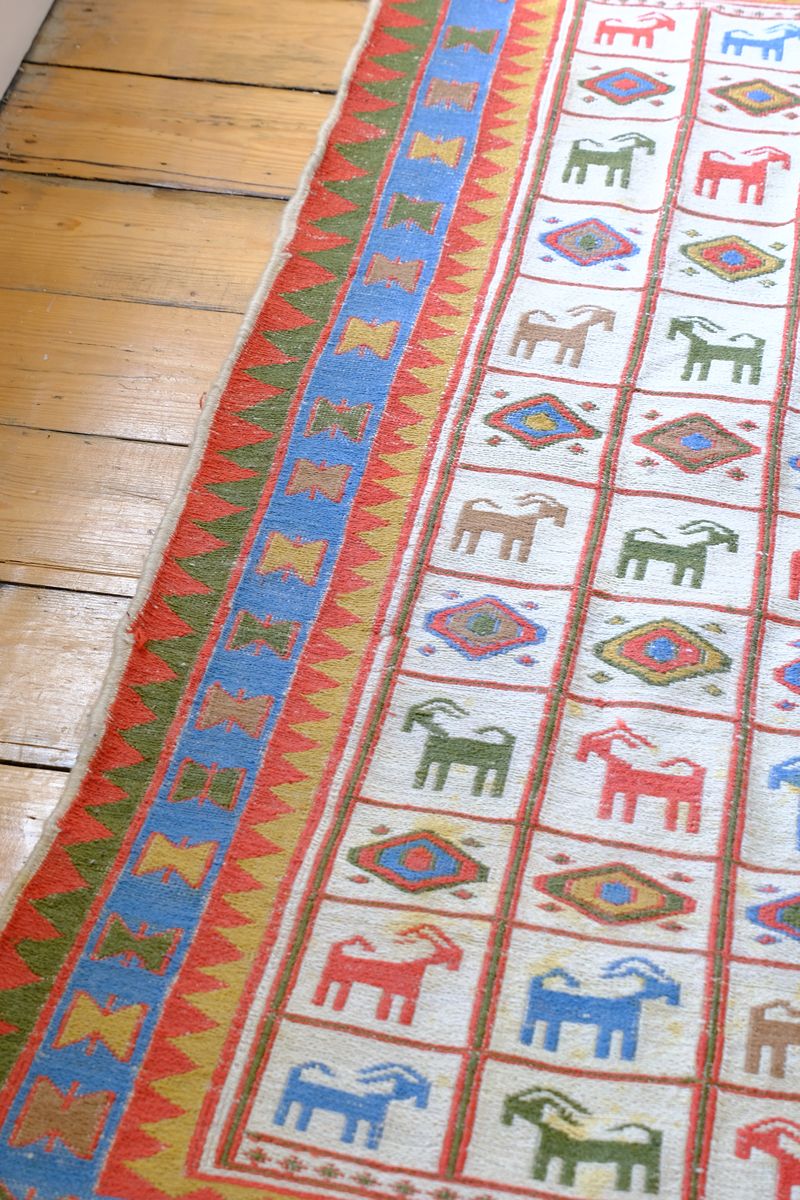 Vintage Persian Sumak flatweave rug with stylised goat and geometric motifs on an ivory ground
