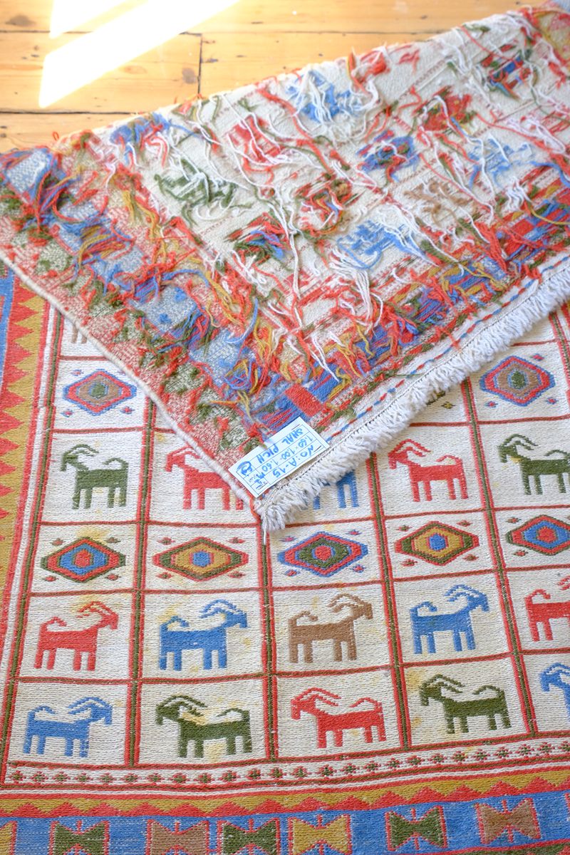 Persian Sumak flatweave rug showing wrapped-weft construction and stylised tribal motifs