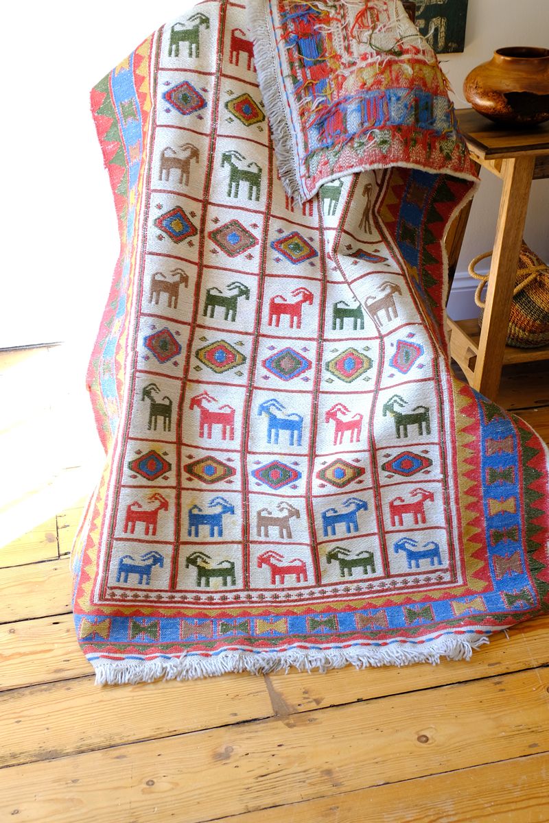 Traditional Persian Sumak wool flatweave rug with repeating goat motifs and geometric design