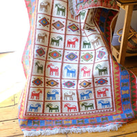 Traditional Persian Sumak wool flatweave rug with repeating goat motifs and geometric design