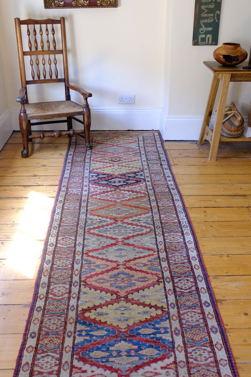 Mid-20th Century North-West Persian ivory ground hand-knotted wool runner with fourteen hooked lozenge medallions