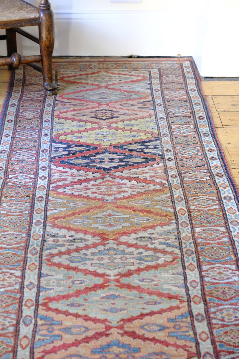 Mid-20th Century North-West Persian ivory ground hand-knotted wool runner with fourteen hooked lozenge medallions