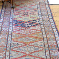 Mid-20th Century North-West Persian ivory ground hand-knotted wool runner with fourteen hooked lozenge medallions