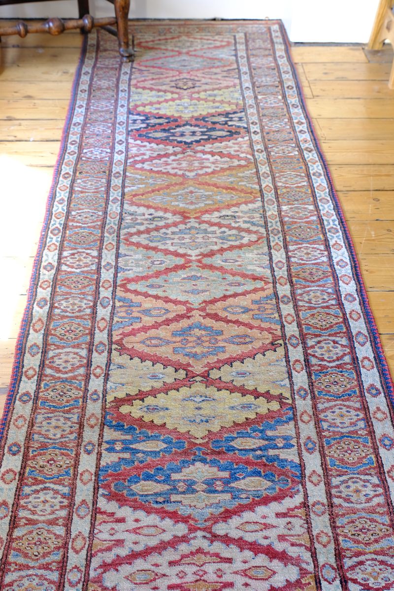 Mid-20th Century North-West Persian ivory ground hand-knotted wool runner with fourteen hooked lozenge medallions
