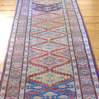 Mid-20th Century North-West Persian ivory ground hand-knotted wool runner with fourteen hooked lozenge medallions