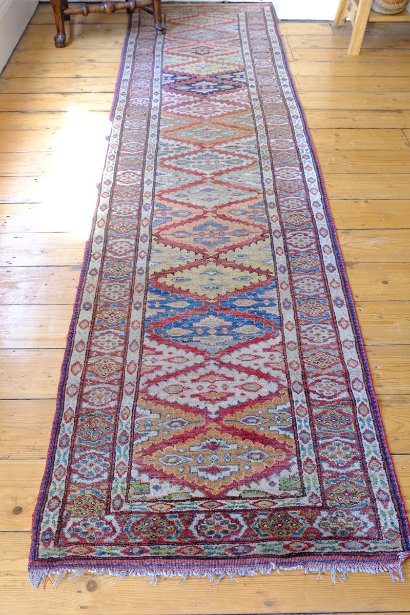 Mid-20th Century North-West Persian ivory ground hand-knotted wool runner with fourteen hooked lozenge medallions