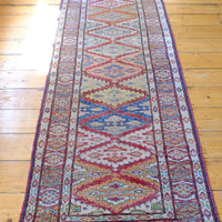 Mid-20th Century North-West Persian ivory ground hand-knotted wool runner with fourteen hooked lozenge medallions