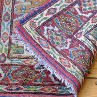 Back of the Mid-20th Century North-West Persian ivory ground hand-knotted wool runner with fourteen hooked lozenge medallions