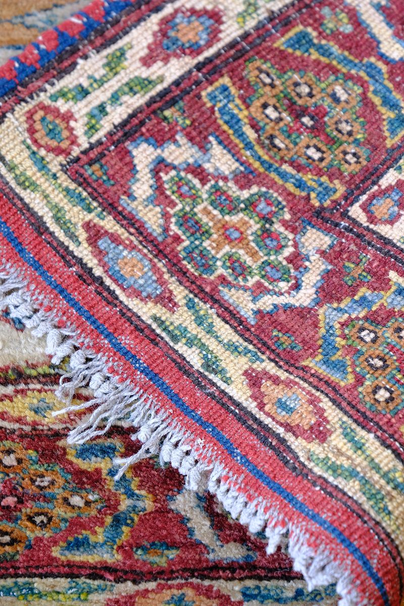 close up of the back of the Mid-20th Century North-West Persian ivory ground hand-knotted wool runner with fourteen hooked lozenge medallions