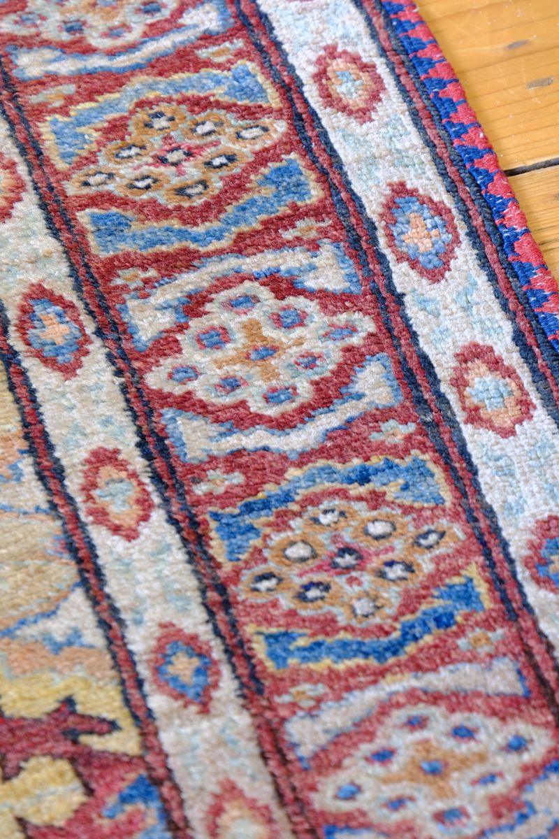 Mid-20th Century North-West Persian ivory ground hand-knotted wool runner with fourteen hooked lozenge medallions
