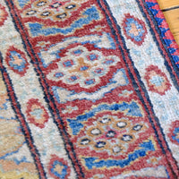 Mid-20th Century North-West Persian ivory ground hand-knotted wool runner with fourteen hooked lozenge medallions