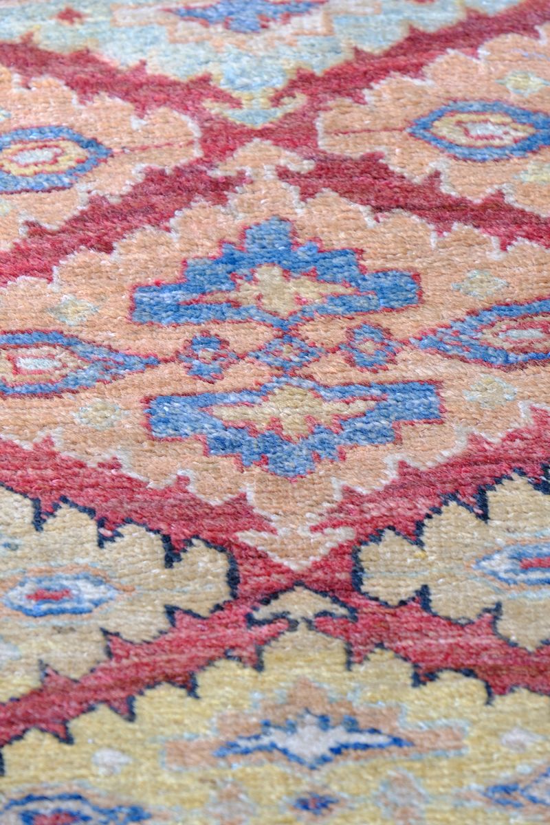 close up of the Mid-20th Century North-West Persian ivory ground hand-knotted wool runner with fourteen hooked lozenge medallions