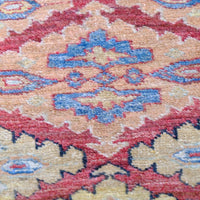 close up of the Mid-20th Century North-West Persian ivory ground hand-knotted wool runner with fourteen hooked lozenge medallions