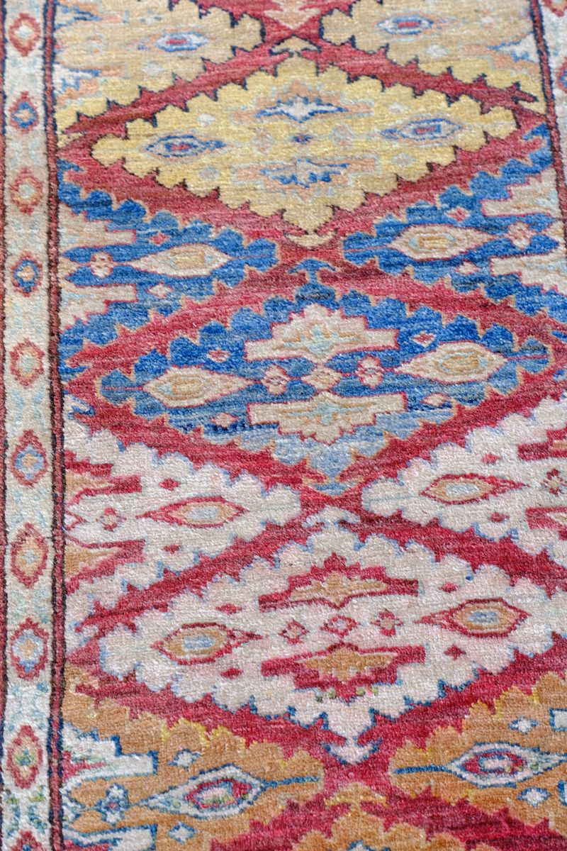 Mid-20th Century North-West Persian ivory ground hand-knotted wool runner with fourteen hooked lozenge medallions