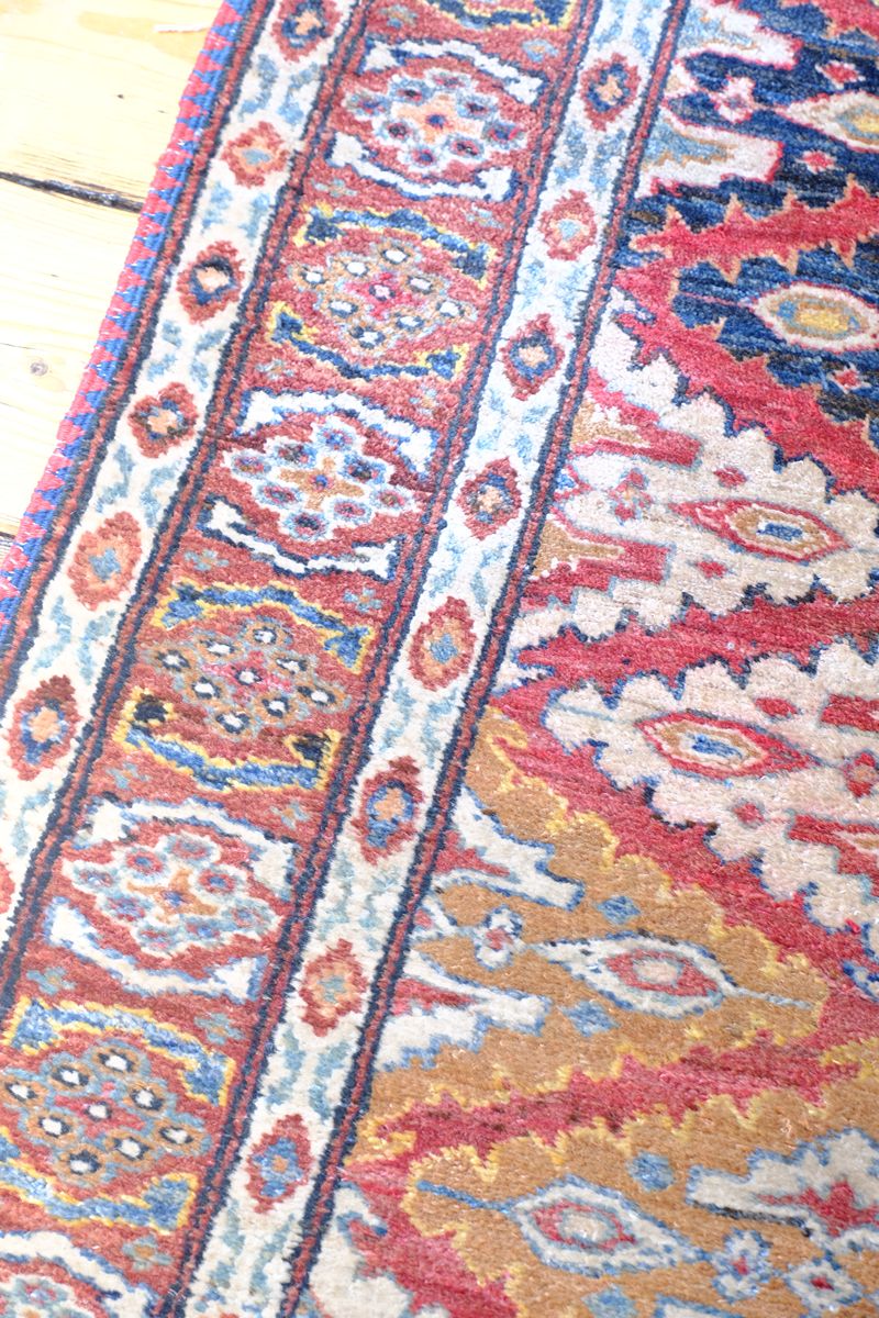 Border on the Hooked lozenge medallions runner - Mid-20th Century North-West Persian ivory ground hand-knotted wool runner with fourteen hooked lozenge medallions