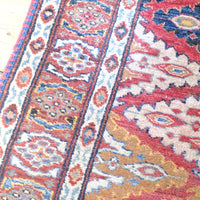 Border on the Hooked lozenge medallions runner - Mid-20th Century North-West Persian ivory ground hand-knotted wool runner with fourteen hooked lozenge medallions
