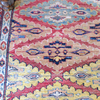 Mid-20th Century North-West Persian ivory ground hand-knotted wool runner with fourteen hooked lozenge medallions