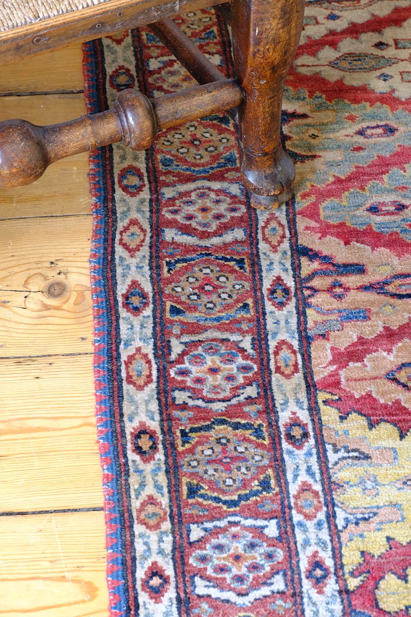 Mid-20th Century North-West Persian ivory ground hand-knotted wool runner with fourteen hooked lozenge medallions