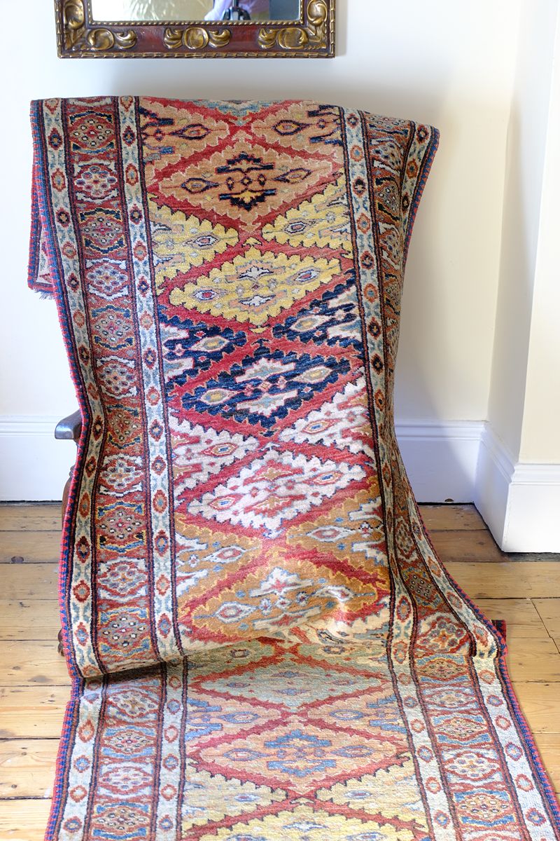 Mid-20th Century North-West Persian ivory ground hand-knotted wool runner with fourteen hooked lozenge medallions