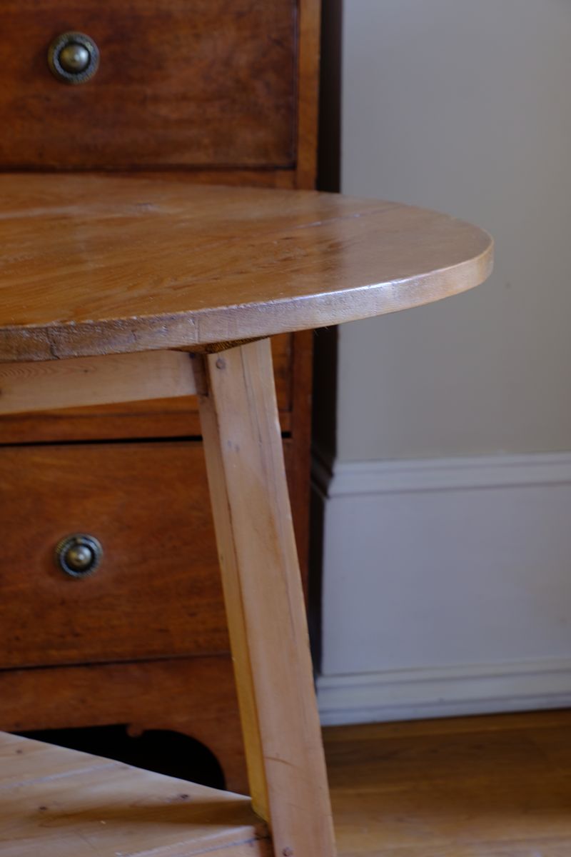 close up on a 19th Century Pine Cricket Supper Table for Two with Triangular Under-Tier Shelf
