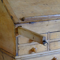Two retractable wooden lopers pull forward to support the fall horizontally, creating a substantial writing surface.. Early 19th Century Georgian Pine Fall-Front Writing Bureau Desk c.1820–1840