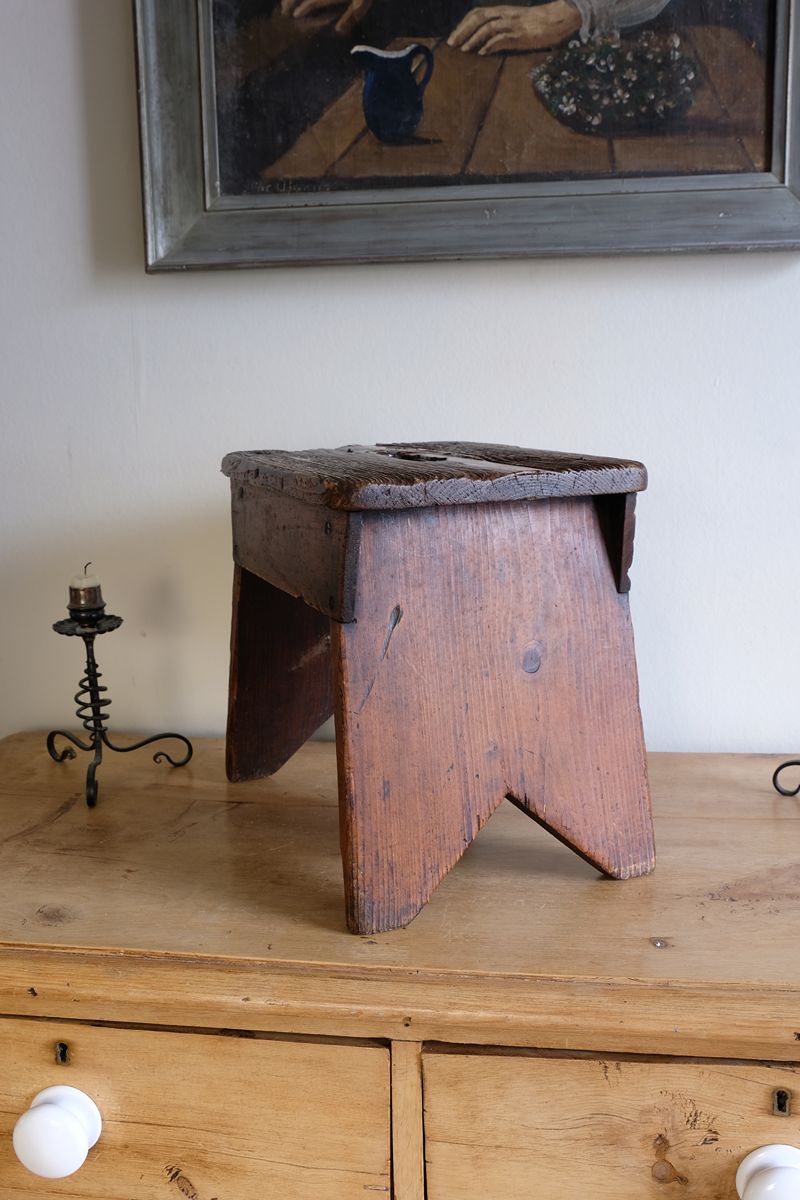 Side view on a 19th Century Vernacular Pine Stool with V-Cut Sides and Worn Grab Handle Seat