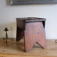 Side view on a 19th Century Vernacular Pine Stool with V-Cut Sides and Worn Grab Handle Seat