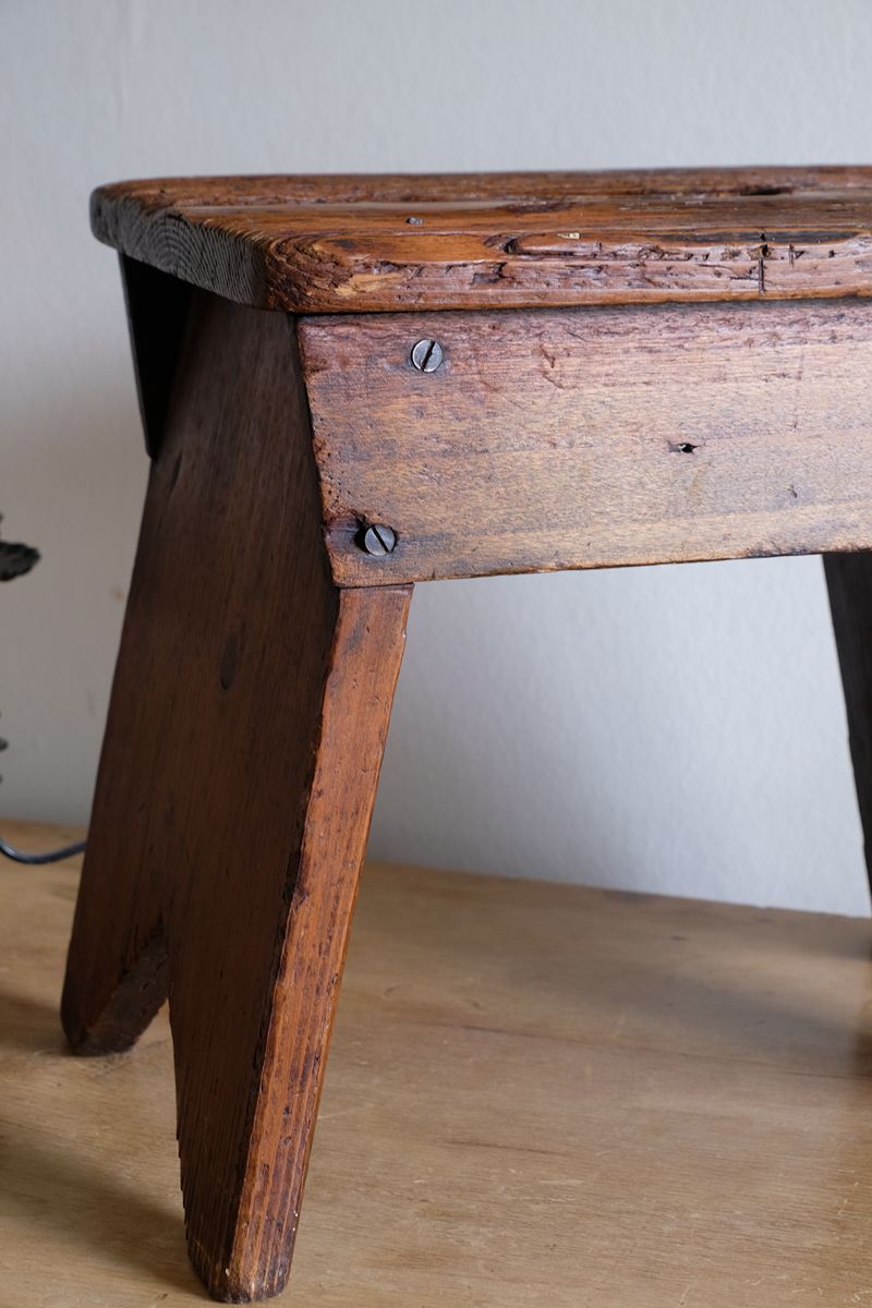 leg and screw detail on a 19th Century Vernacular Pine Stool with V-Cut Sides and Worn Grab Handle Seat