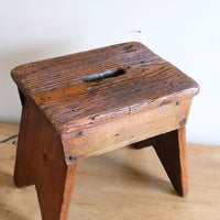 Looking at the top of a 19th Century Vernacular Pine Stool with V-Cut Sides and Worn Grab Handle Seat