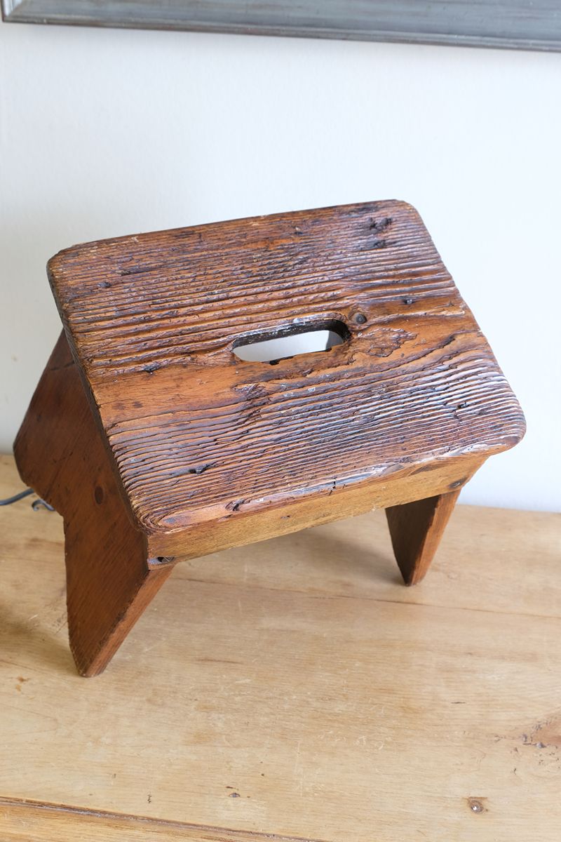 Rigid grain on a 19th Century Vernacular Pine Stool with V-Cut Sides and Worn Grab Handle Seat