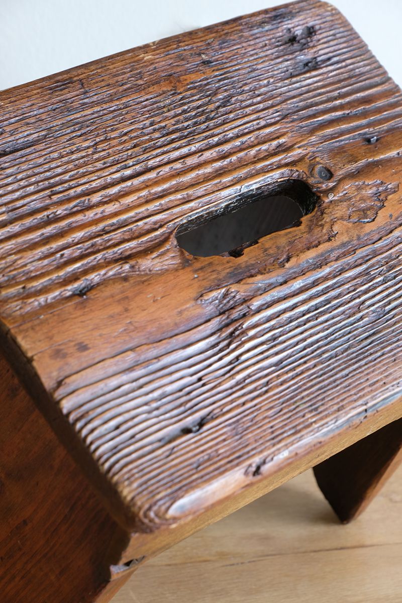 Grab grab hole on a 19th Century Vernacular Pine Stool with V-Cut Sides and Worn Grab Handle Seat